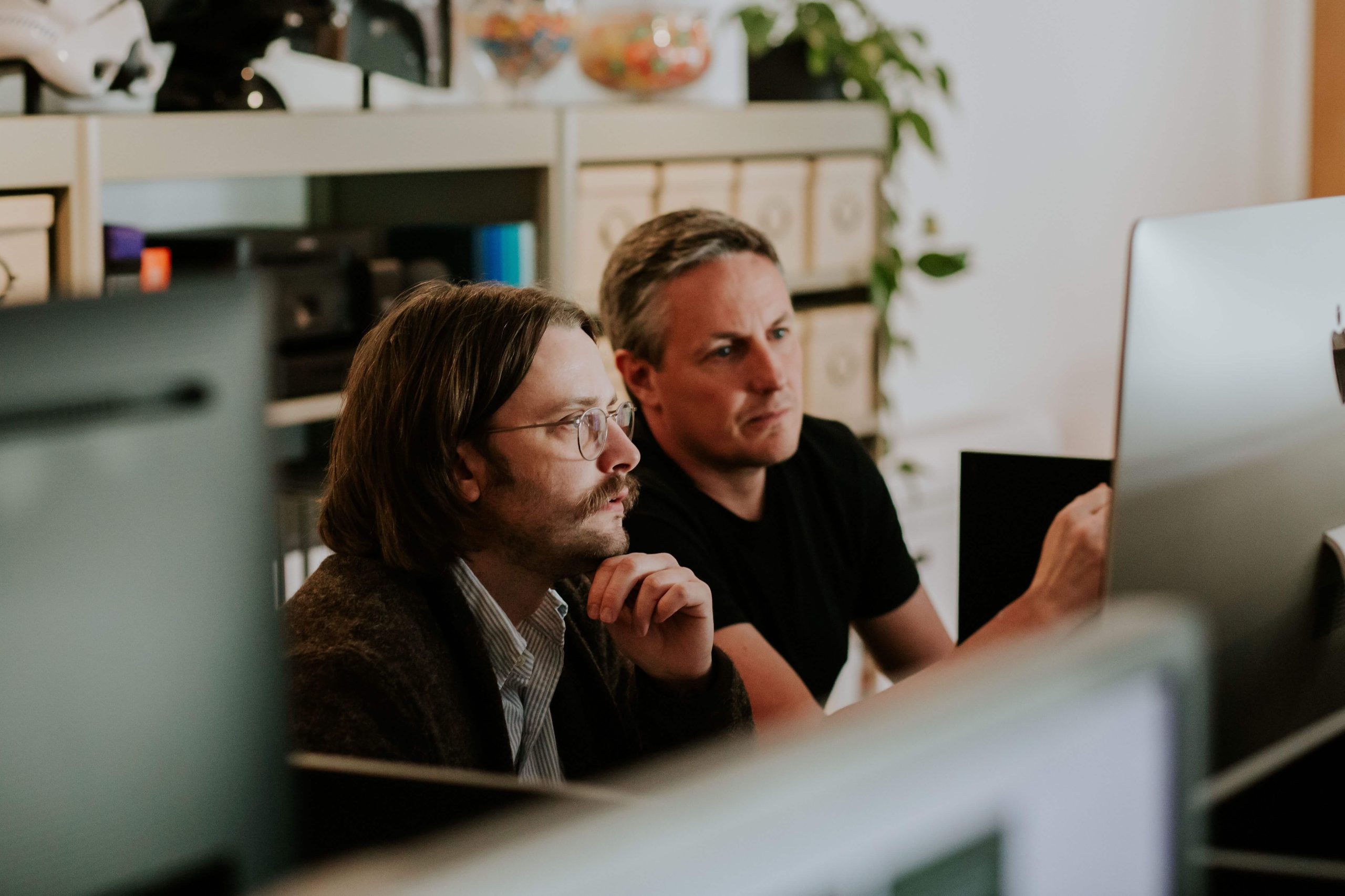 two men looking at computer screen