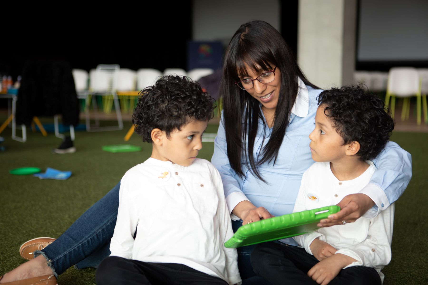 kids and teacher reading tablet