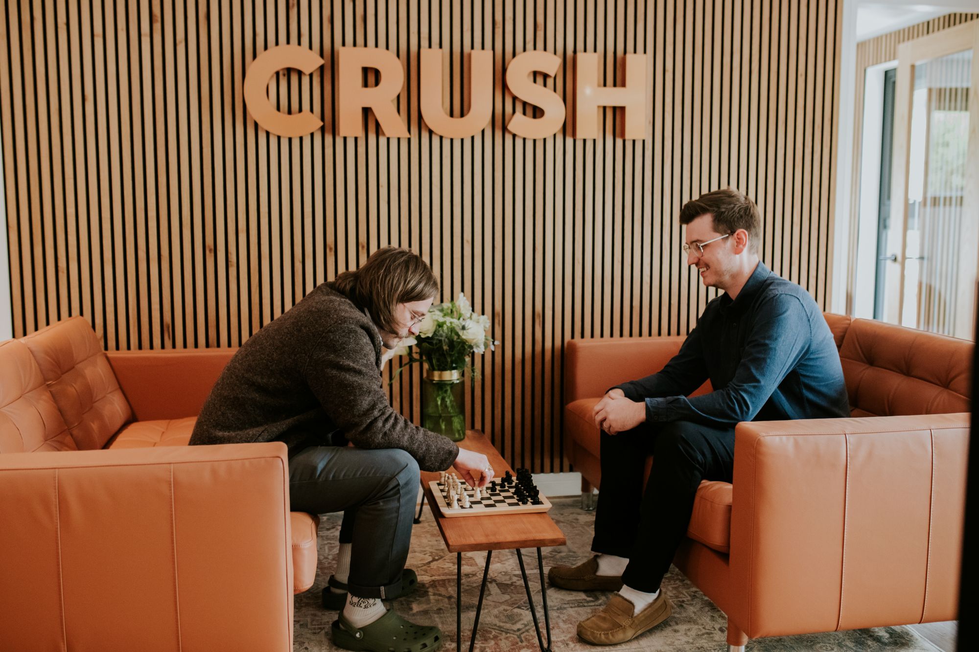 two guys playing chess together in studio